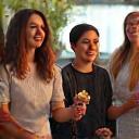 A diverse group of smiling professionals, possibly florists, engaging in conversation at a professional event, symbolizing a strong alumni network.